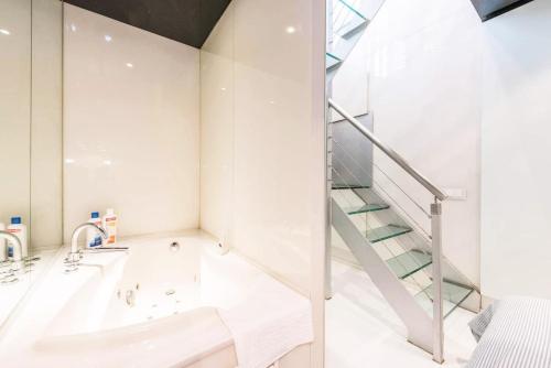 a bathroom with a sink and a staircase at My City Home - Dúplex PH III in Madrid