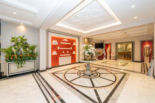 a lobby with a table and flowers on the floor at The Byzantium Suites Hotel & Spa in Istanbul