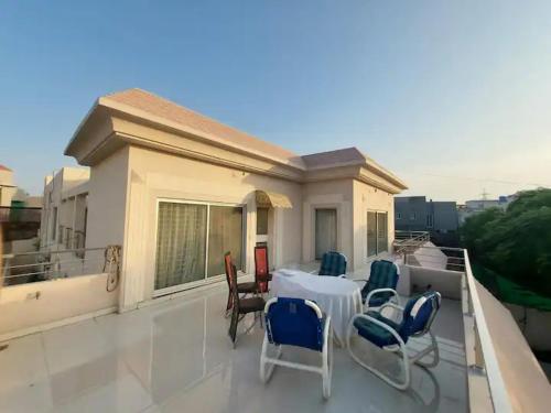 a balcony with chairs and a table on a house at 5 Bedrooms furnished separate upper portion house in DHA Phase 4, Lahore in Lahore