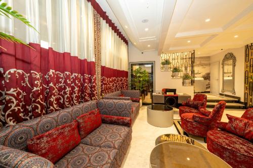 a living room with couches and chairs in a room at The Byzantium Suites Hotel & Spa in Istanbul