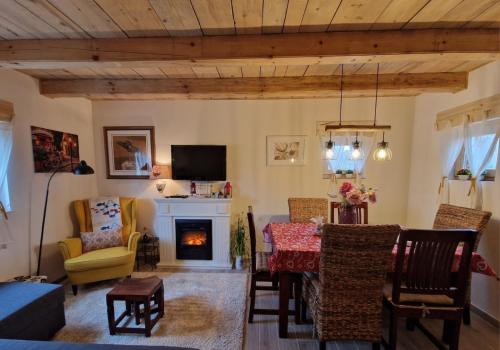 sala de estar con mesa y chimenea en DRiM Wood House, en Lasinja