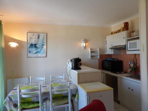 een keuken met een tafel en stoelen bij Vue superbe sur la Belle Bleue avec 2 chambres in Saint-Cyprien