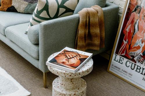 a table with a box on it next to a couch at Mason & Fifth, Primrose Hill in London