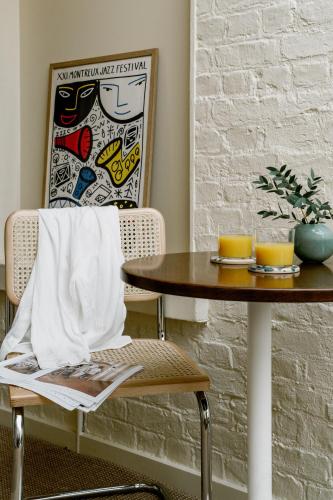a table and a chair with a napkin on it at Mason & Fifth, Primrose Hill in London