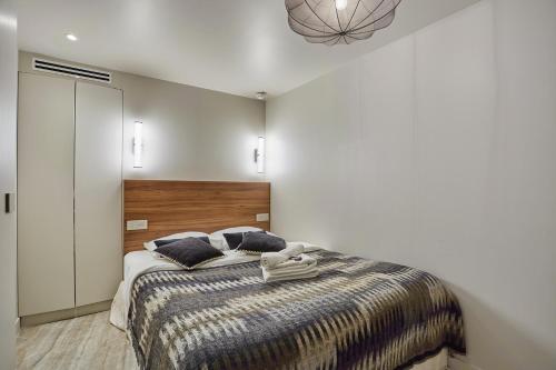 a bedroom with a bed with two pillows on it at Apart hotel Centre de Paris by Studio prestige in Paris