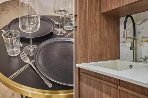 a kitchen with a table with glasses and a sink at Apart hotel Centre de Paris by Studio prestige in Paris