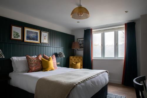 a bedroom with a large bed and a window at The Bridge Hotel in Chertsey