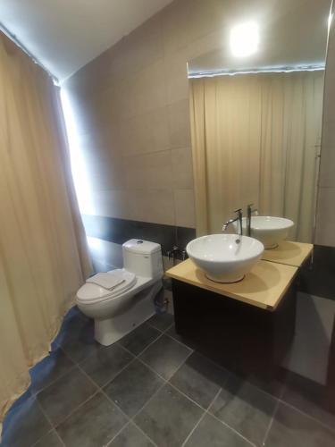 a bathroom with a toilet and a sink at Grand Kapar Hotel Kuala Selangor in Kuala Selangor