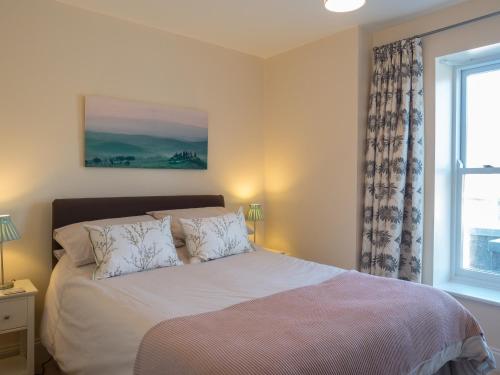 a bedroom with a bed and a window at St Brides View Solva in Solva