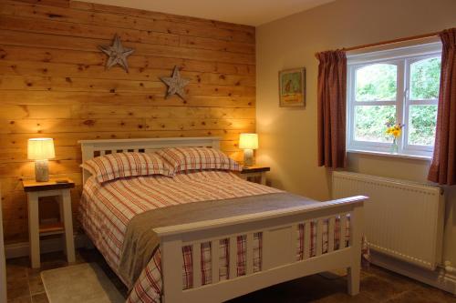 a bedroom with a bed and stars on the wall at The Hideaway Brongest in Troedyraur