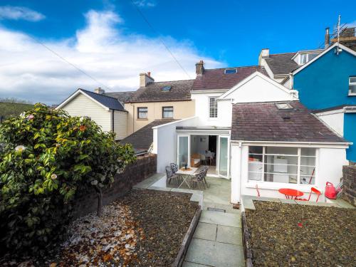 a home with a patio and a house at Brodawel New Quay in New Quay