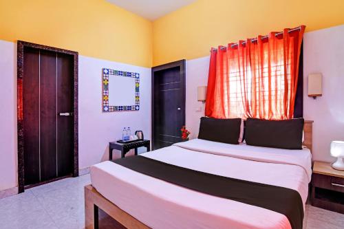 a bedroom with a large bed and a window at OYO Home Modern Stay Near Iter in Khandagiri