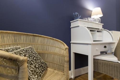 a living room with a couch and a table with a microwave at Household Settembrini in Milan