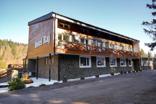a building with a balcony on the side of it at Hotel Raj in Dedinky