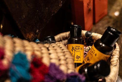 a wicker basket with bottles of oils in it at Kasbah Hotel Xaluca Arfoud in Erfoud