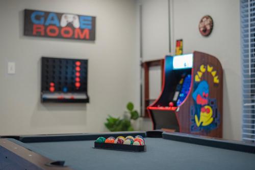a ping pong table with a video game at Pool, Gameroom & Minigolf Enchanting Texas Home in San Antonio