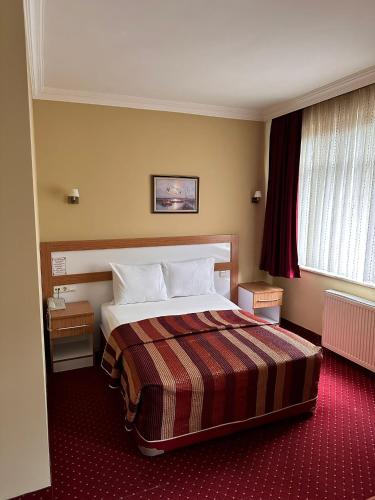 a hotel room with a bed in a room at Minabir Otel in Ankara