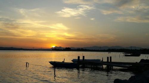 a group of boats docked at a dock on a lake at Il Fenicottero Elmas in Elmas