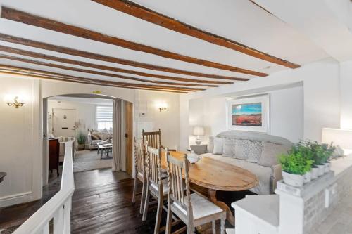 a living room with a table and a couch at North End House - Batheaston in Bath