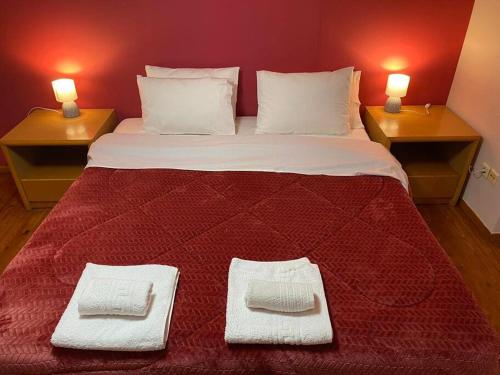 a large bed with two pillows and two lights on top at Μεζονέτα AIKATERINI N 17 in Chios