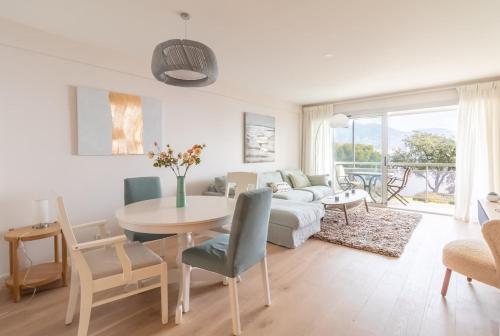 a living room with a table and a couch at Magnificent 2-room Apartment Sea View Roquebrune in Roquebrune-Cap-Martin