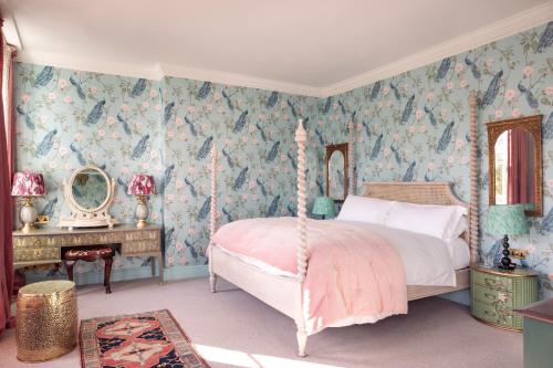 a bedroom with a bed and a table with a mirror at The Portobello Hotel in London