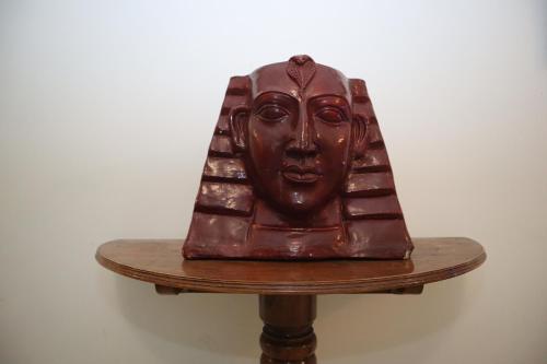 a brown statue of a face on a table at SWET APARAJITA in Bolpur