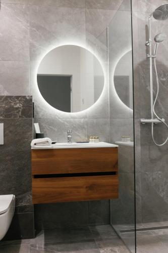 a bathroom with a sink and a mirror at Select Hotel in Lviv