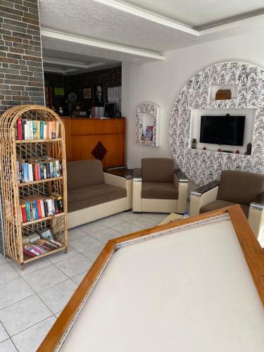 a living room with a pool table and a tv at Sevgi Hotel Kalkan in Kalkan