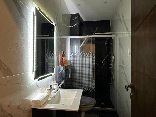 a bathroom with a sink and a shower at Luxury Abdoun apartment in Amman