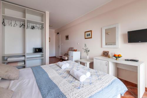 a bedroom with a bed with two pillows on it at Mila & Aleksandr Apartments in Budva