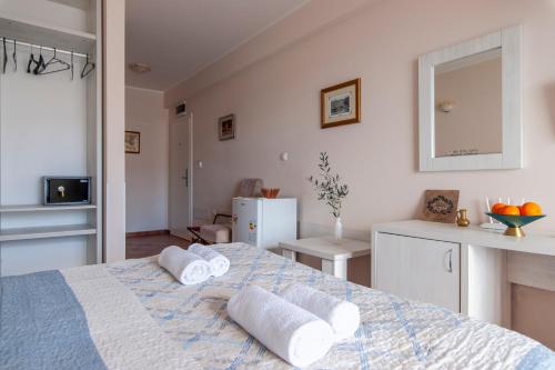 a bedroom with a bed with towels on it at Mila & Aleksandr Apartments in Budva