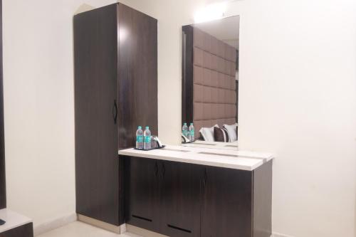 a bathroom with a sink and a mirror at HOTEL C COMFORT in Visakhapatnam