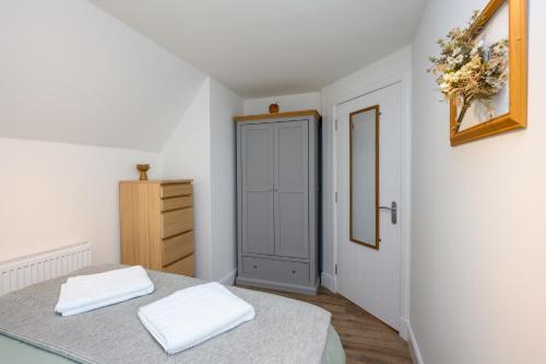 a bedroom with a bed and a closet and a door at Old Town Loft in Cupar