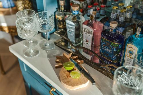 a counter with glasses and bottles of alcohol on it at Last Word Franschhoek in Franschhoek