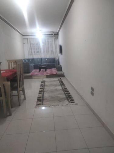 an empty living room with a table and a couch at شقة فندقية للايجار in Cairo