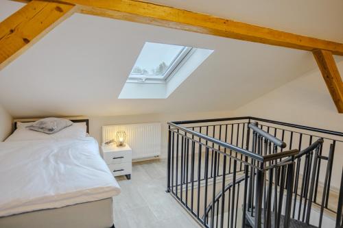 a attic bedroom with a bed and a skylight at Rezidence Petra Voka in Třeboň