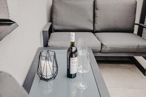 a bottle of wine and two glasses on a table at Rezidence Petra Voka in Třeboň