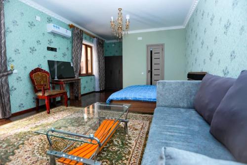 a living room with a couch and a bed at ALI HOSTEL in Dushanbe