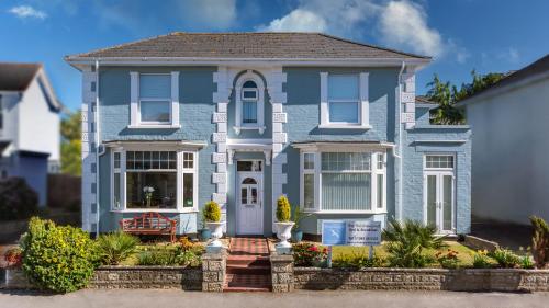 a blue house with white trim at The Richmond Bed and Breakfast - Adults only in Shanklin