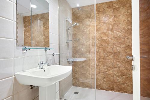 a bathroom with a sink and a shower at Silkhaus Modern Studio Near Silicon Central Mall in Dubai