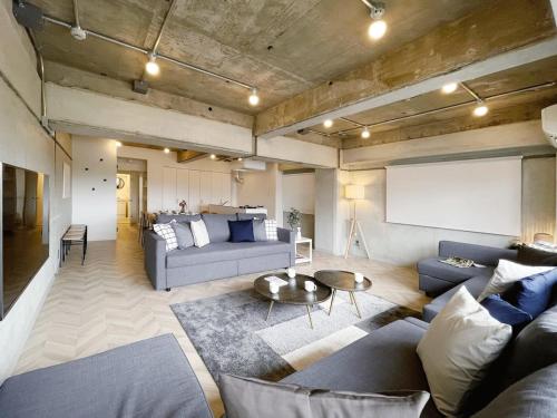 a living room with a couch and a table at b hotel Dai3Himawari - Up to 10p 1 min Peace Park, Wonderful huge house in Hiroshima