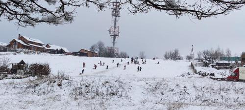 a group of people playing in the snow at Pension Panorama in Odorheiu Secuiesc