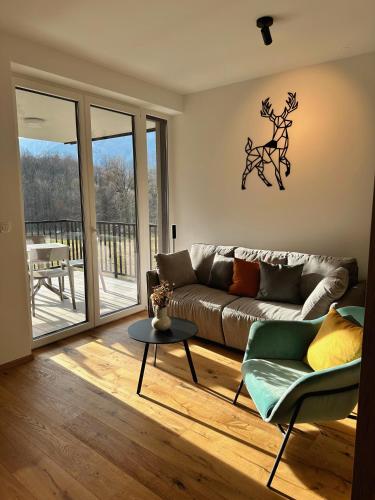 a living room with a couch and a table at Soca Valley Suites in Bovec