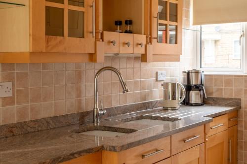 a kitchen with a sink and a counter top at Lovely 2BR in peaceful Hampstead, NW London in London