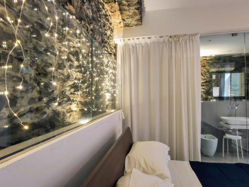 a bedroom with a bed with lights on the wall at ca' di sotto in Riomaggiore