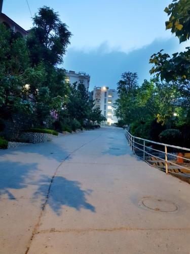 a street in a park with trees and a fence at Yogvan Luxury 1BHK Apartments Tapovan Rishikesh in Rishīkesh