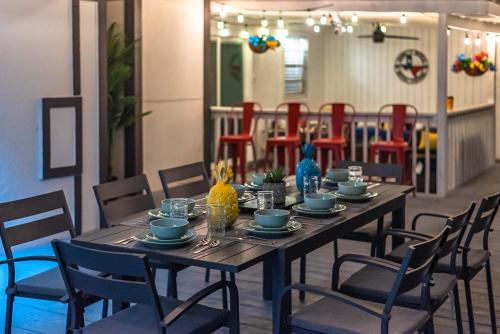 a dining room table with chairs and a tableasteryasteryasteryasteryasteryasteryastery at Pool, Gameroom & Minigolf Enchanting Texas Home in San Antonio