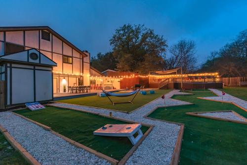 a house with a playground in the yard at Pool, Gameroom & Minigolf Enchanting Texas Home in San Antonio