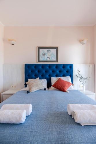 a blue bed with two towels on top of it at Mila & Aleksandr Apartments in Budva
